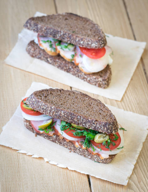 istock Fresh sandwich on a wooden table with burlap. 638921262