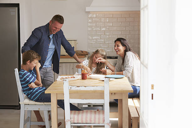 istock Family At Home In Kitchen Making Pizzas Together 638922748