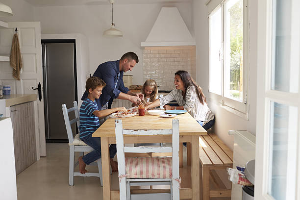 istock Family At Home In Kitchen Making Pizzas Together 638922768