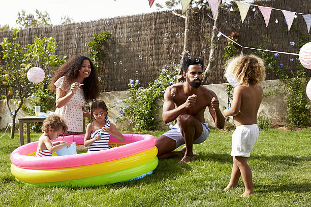 istock Family Having Fun In Garden Paddling Pool 638923614
