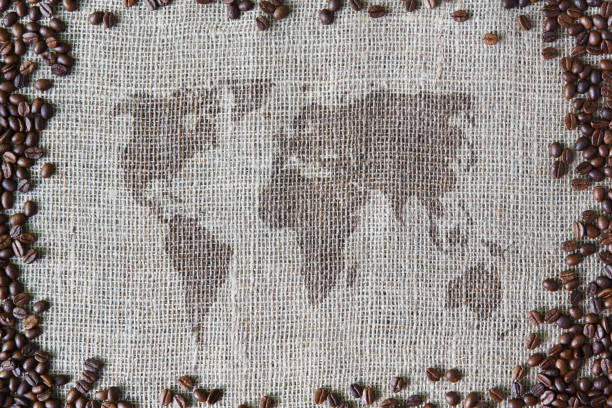 istock Burlap texture with coffee beans border and world map 638923938