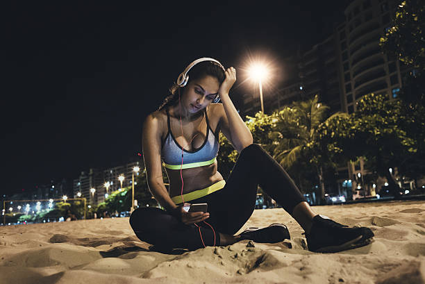 istock tired jogger resting after workout on the beach at night 638924020