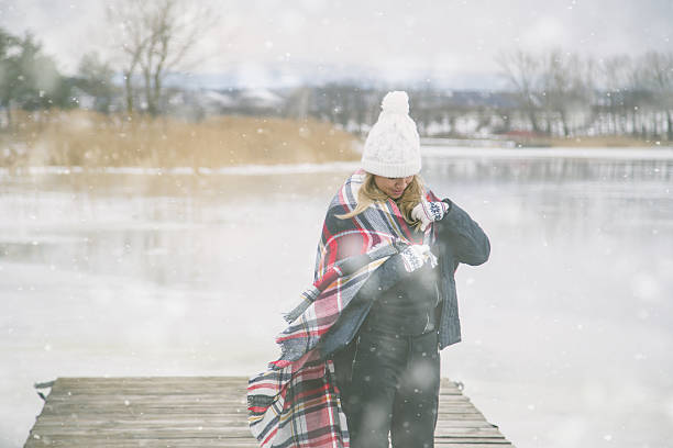 young woman in the snow wearing a checkered blanket - winter lake snow fog imagens e fotografias de stock