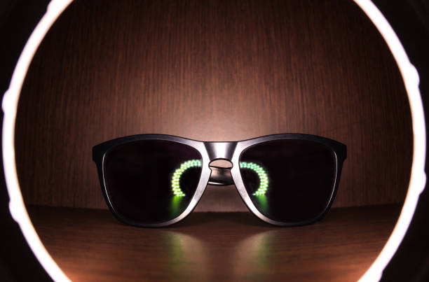 istock black Sunglasses on wood floor with led ring light reflect 638925580