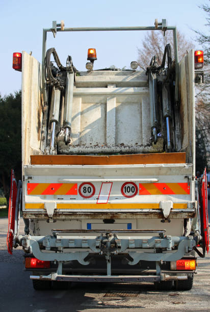 istock Industrial large garbage trucks during the solid waste collectio 638925620
