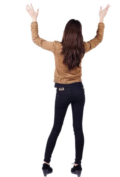 istock back view of surprised brunette woman with hands up. 638929356