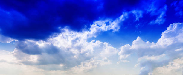 Horizontal vivid blue cloudscape dramatic clouds background back stock photo