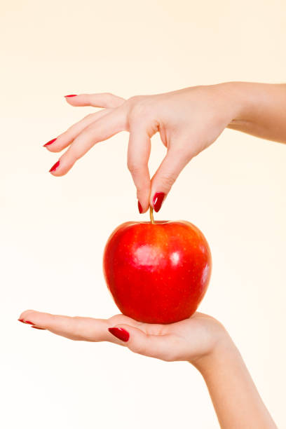 istock Woman hand holding delicious red apple 638931856