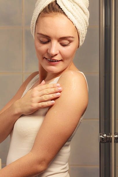 istock Woman applying moisturizer cream on her body 638933164