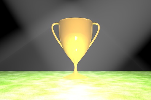 Golden cup over grass field, 3d rendering