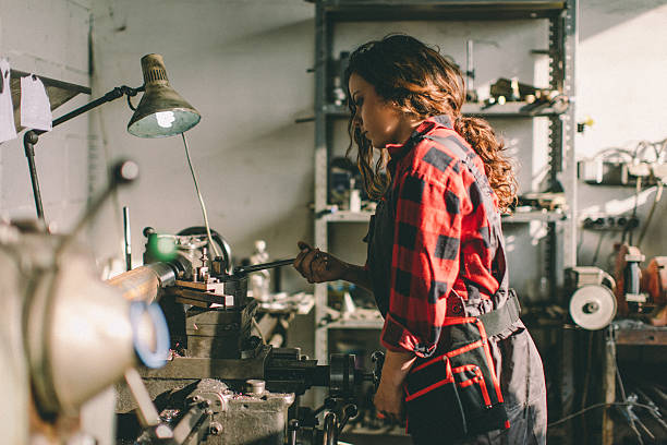 istock Woman on lathe machine... 638934284