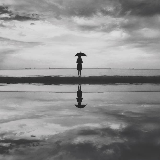 istock Starring out to Sea with umbrella 638935366