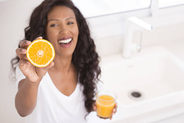 Woman drinking fresh orange juice.