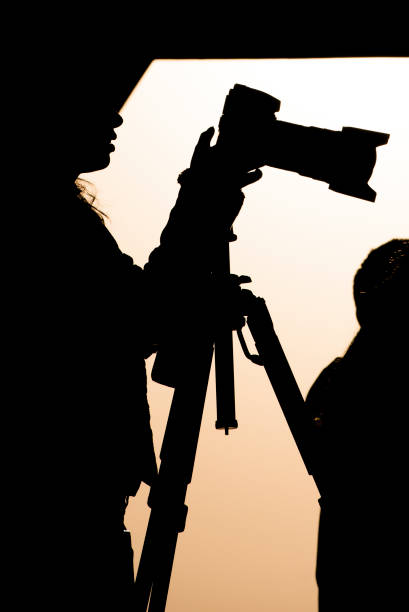 istock photographer silhouette at sunset 638940088