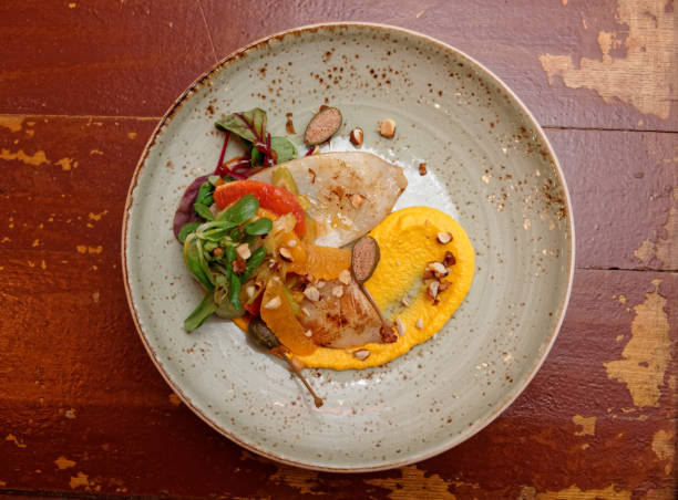 istock Seafood starter with orange slices and pumpkin mash 638942588
