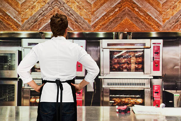 istock Rear view of chef standing in kitchen 638942600