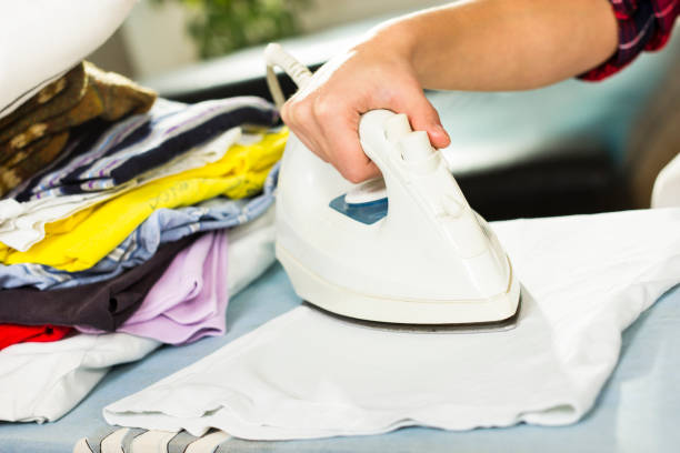 istock Close up of hand ironing clothes. 638942902