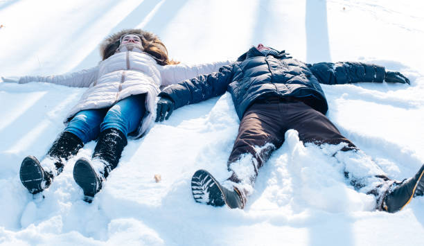 istock couple having fun in snowy park 638942908
