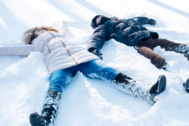 istock couple having fun in snowy park 638942966