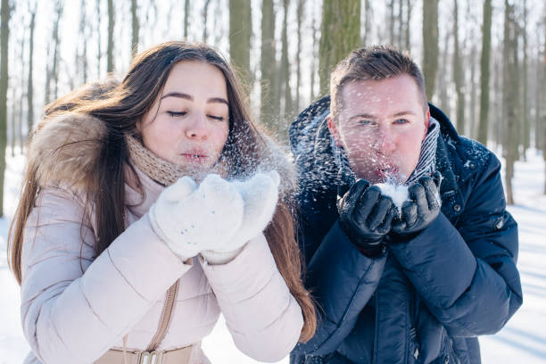 istock couple having fun in snowy park 638943178