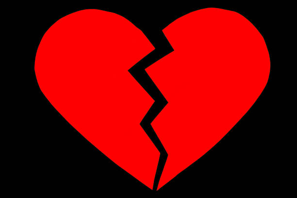 Red heartbreak / broken heart. close up of a paper stock photo