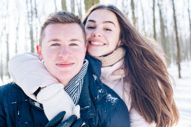 istock couple having fun in snowy park 638943516