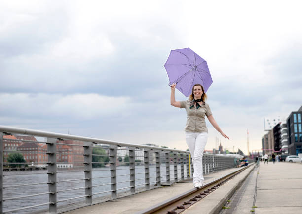 happy businesswoman with umbrella