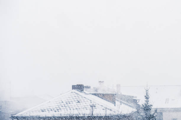 istock snow cityscape / rooftops during winter snowing 638949162