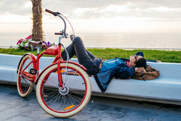 istock woman with bicycle enjoying the sun on seaside 638949346