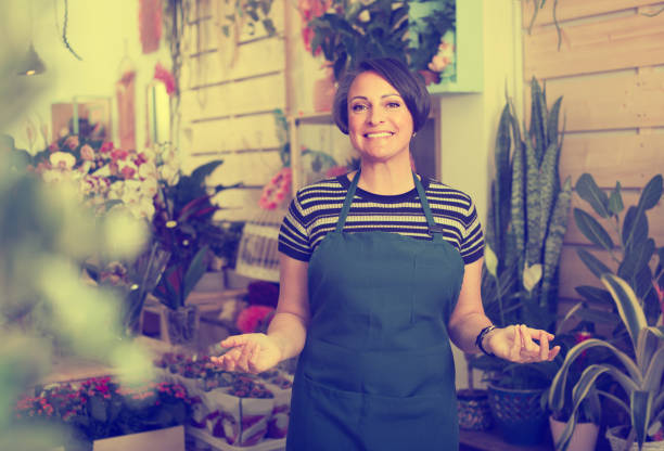 istock florist smiling among plants 638949690