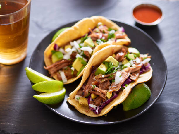 istock mexican carnita street tacos with beer on slate table setting 638949916
