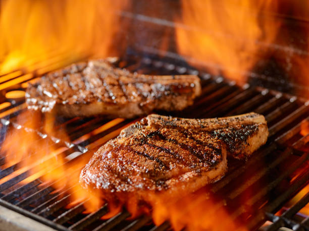 istock two rib-eye steaks grilling on the open flame 638951254