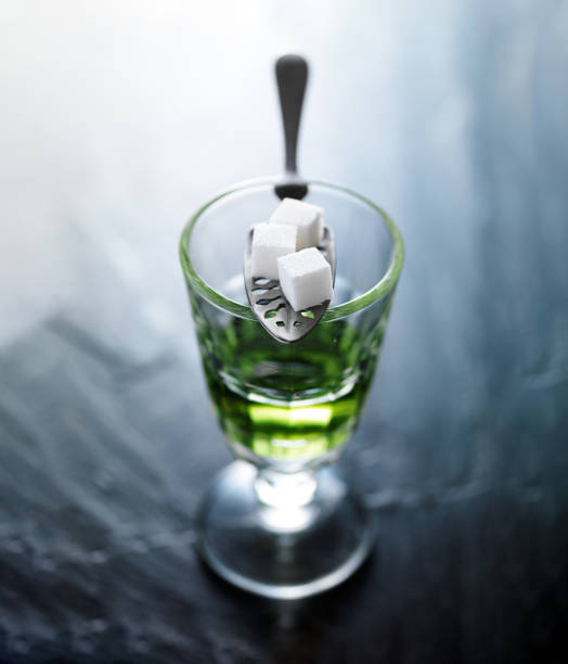 absinthe in pontarlier glass absinthe in pontarlier glass with spoon and sugar cubes absinthe spoon stock pictures, royalty-free photos & images