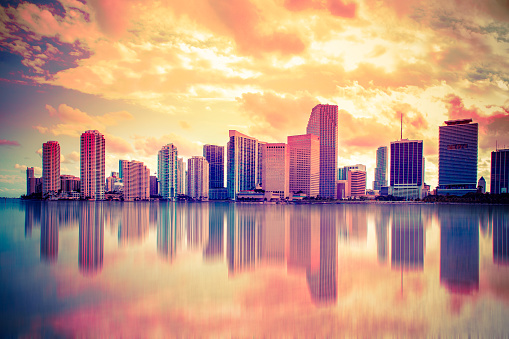 Beautiful colorful city of Miami Florida skyline and bay with dramatic clouds at sunset