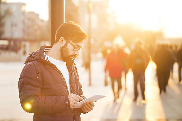 istock Young man with digital tablet in the city 638951942