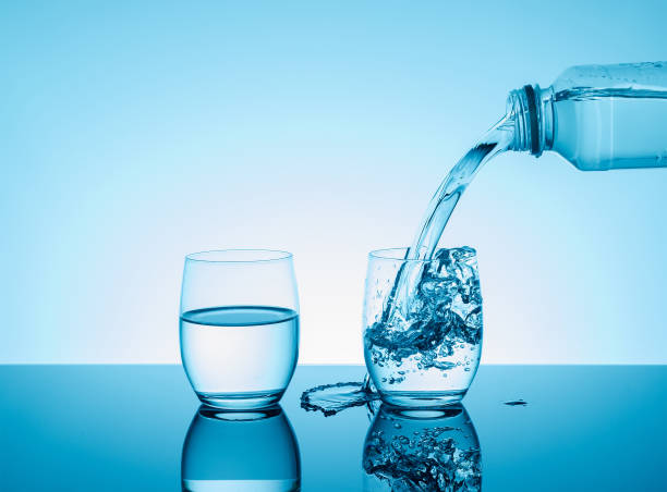 istock Bottle with creative splashing water in the glass 638952344