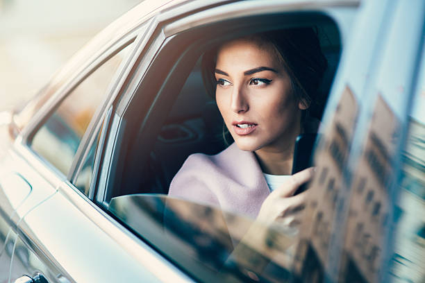 istock Woman using a smart phone in a car 638952434