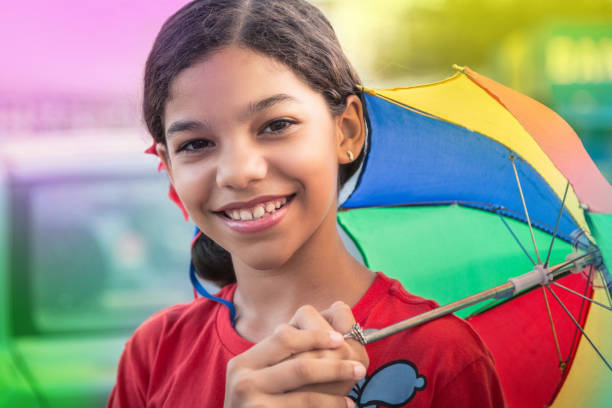 Girl at carnaval Smiling girl at carnival holding a colorful umbrella axe throwing stock pictures, royalty-free photos & images