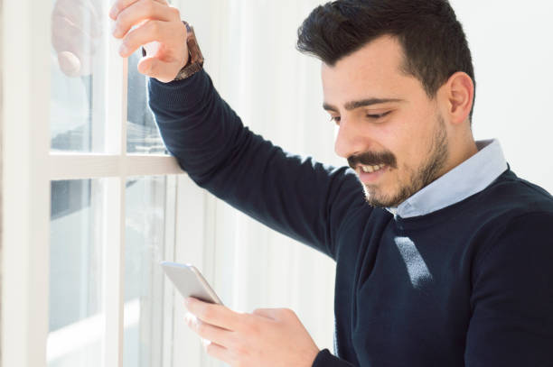 istock Handsome business man reading an SMS on smartphone 638953974