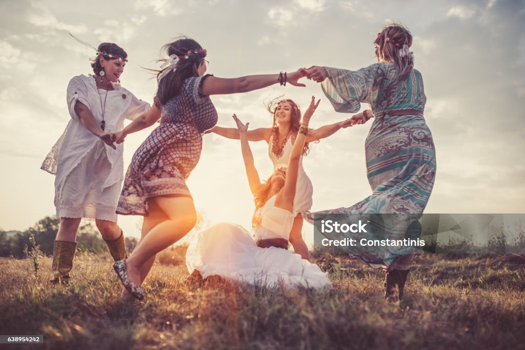 Friends Group of happy female friends running on meadow. Women Stock Photo