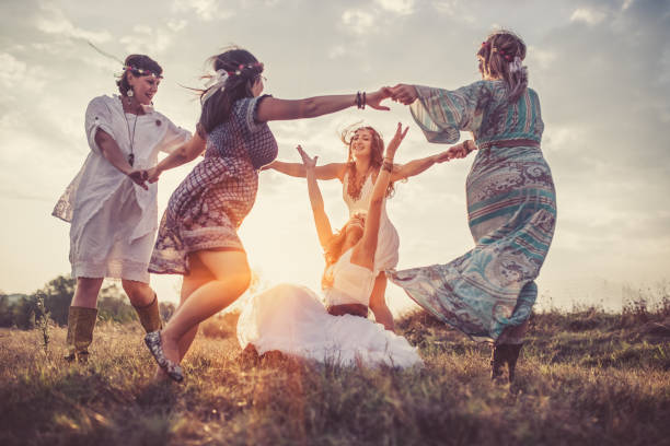 Friends Group of happy female friends running on meadow. traditional ceremony photos stock pictures, royalty-free photos & images