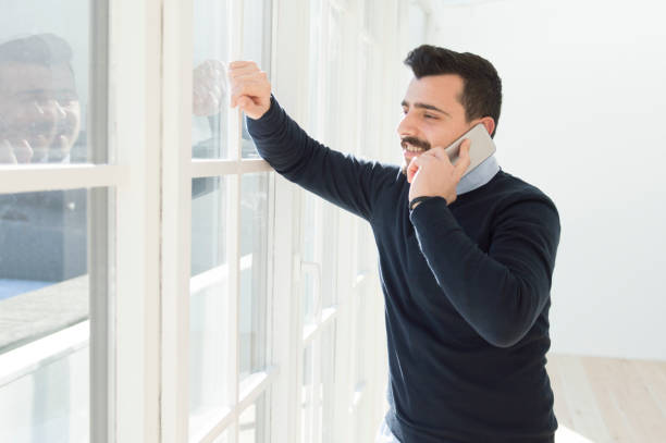 istock Cool young business man on the phone looking away 638955116