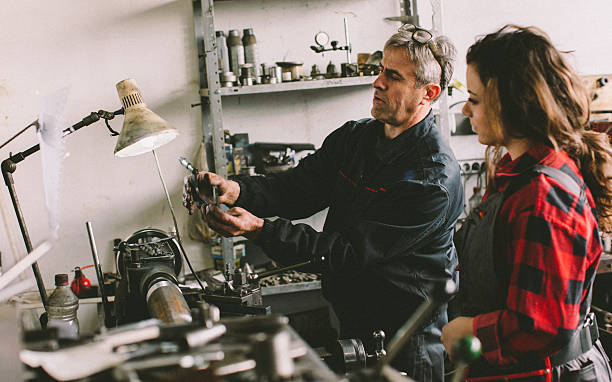 istock Senior man teaching her how to use lathe... 638958178
