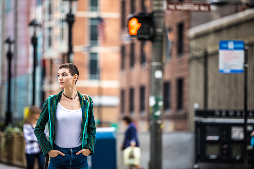 Woman in downtown Chicago waiting to cross the street, USA.