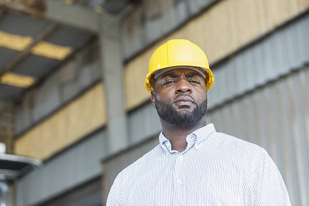 istock African American man in warehouse wearing hardhat 638960016