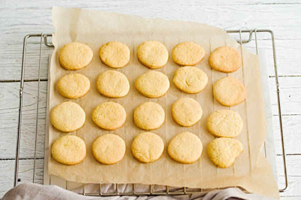 istock Orange butter cookies on a baking paper and wire rack 638960148