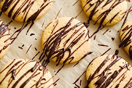 Dark chocolate covered butter cookies with  on a baking paper