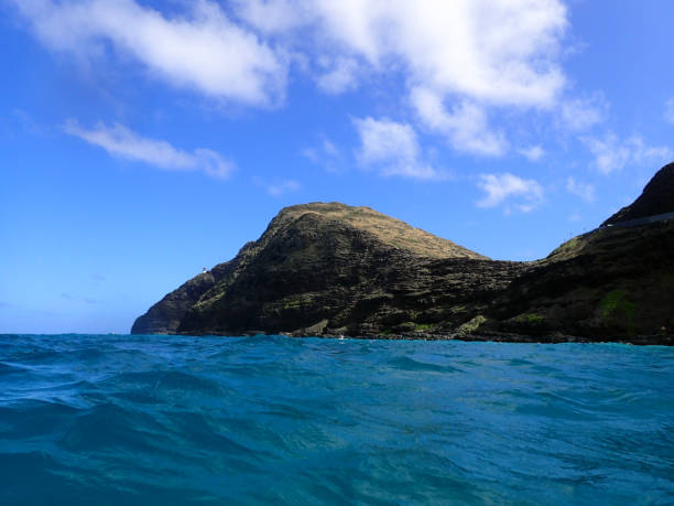 istock Ocean waves ripple with Makapuu Lighthouse and point 638960368