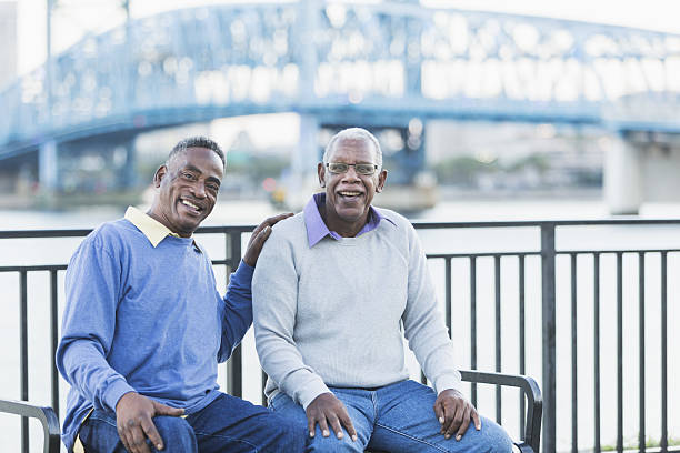 istock Two senior African American men on bench by waterfront 638960406
