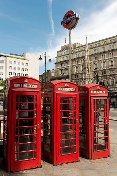 Charing Cross London, United Kingdom - June 15, 2016: Red London phone booths late in the day in Trafalgar Square at the Charing Cross Station. british telecom photos stock pictures, royalty-free photos & images